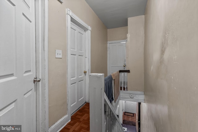 corridor with dark parquet flooring