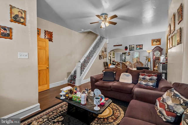 living room featuring ceiling fan and hardwood / wood-style flooring