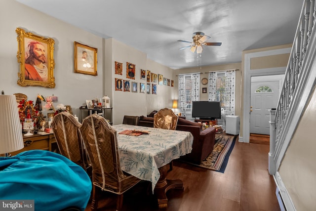 dining area with ceiling fan, dark hardwood / wood-style flooring, and a baseboard heating unit