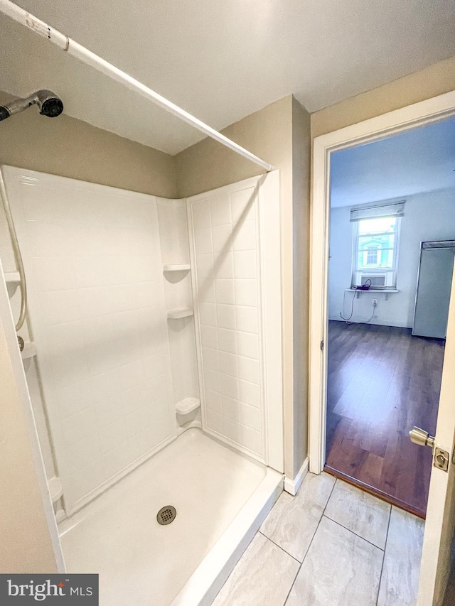 bathroom with cooling unit, hardwood / wood-style floors, and walk in shower