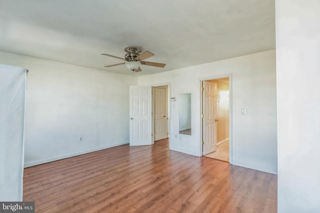 empty room with light hardwood / wood-style floors and ceiling fan