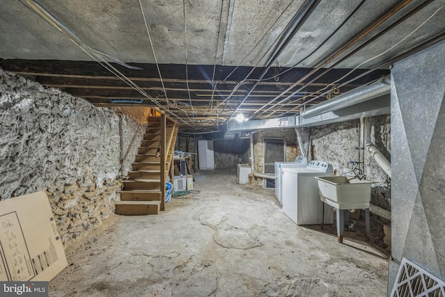 basement with independent washer and dryer and sink