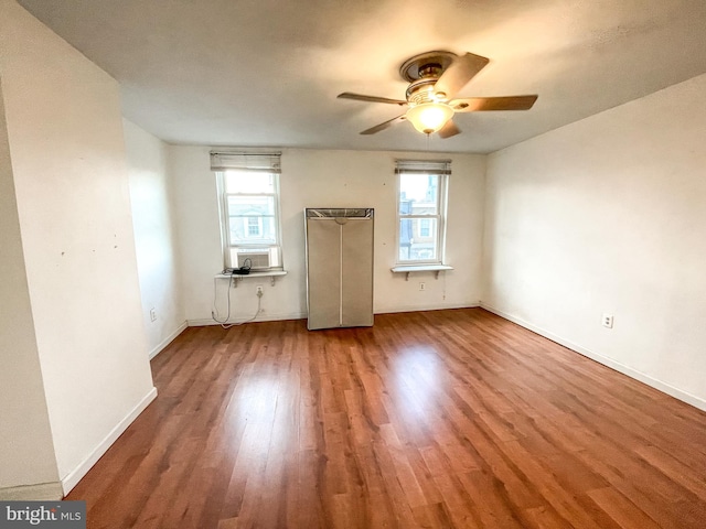 unfurnished room with cooling unit, wood-type flooring, plenty of natural light, and ceiling fan