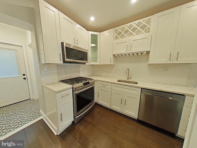 kitchen featuring white cabinets, stainless steel appliances, sink, and dark hardwood / wood-style flooring