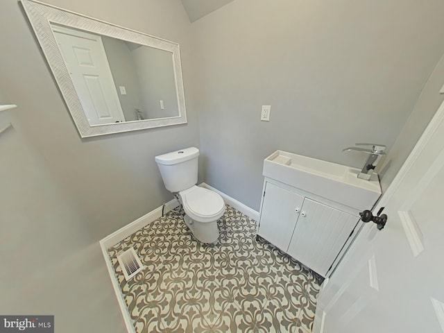 bathroom featuring toilet, vanity, and tile patterned floors