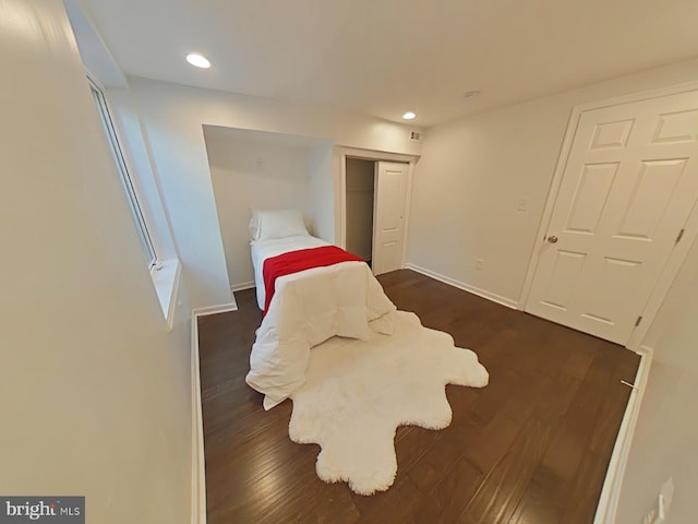 bedroom with a closet and dark hardwood / wood-style flooring