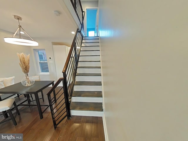 stairs featuring hardwood / wood-style floors