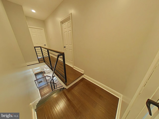 staircase with wood-type flooring