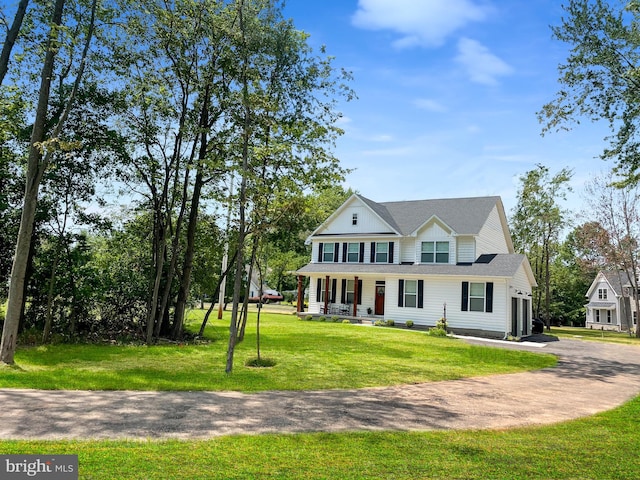 view of front of property featuring covered porch and a front lawn