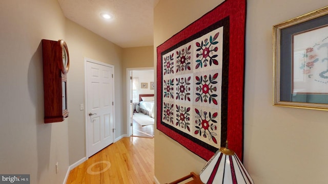 hall featuring baseboards and light wood-style floors