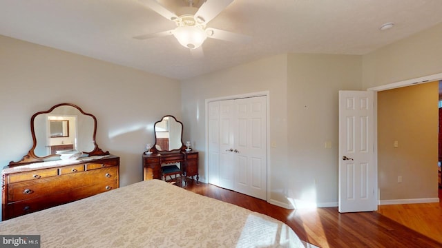 bedroom featuring ceiling fan, a closet, baseboards, and wood finished floors