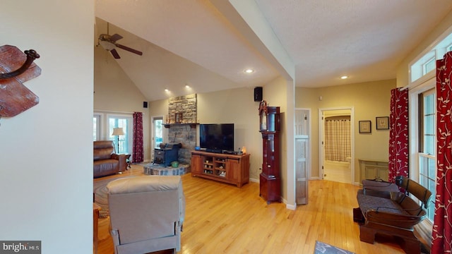 living area with high vaulted ceiling, recessed lighting, a ceiling fan, baseboards, and light wood-style floors