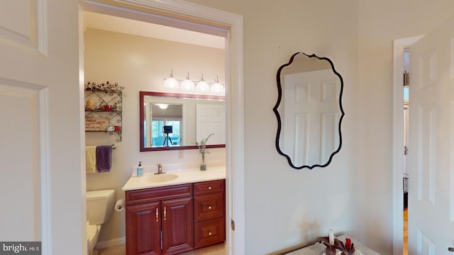 bathroom featuring toilet and vanity