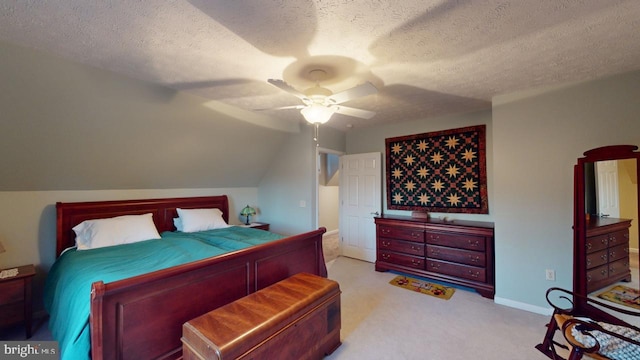 carpeted bedroom with a textured ceiling, lofted ceiling, a ceiling fan, and baseboards