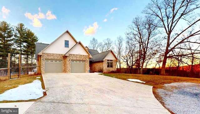 view of front of home with an attached garage, fence, and concrete driveway