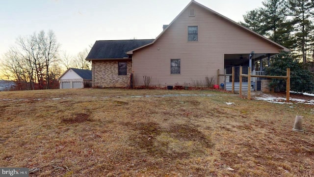 view of property exterior featuring an outdoor structure and a detached garage