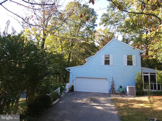 view of property exterior featuring cooling unit and a garage