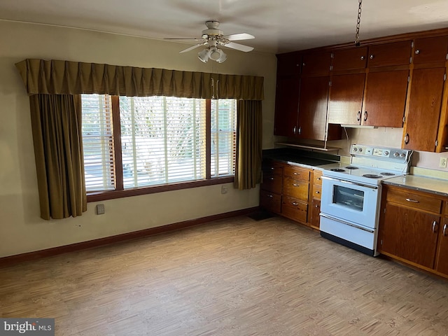 kitchen with electric stove, light wood-type flooring, and ceiling fan