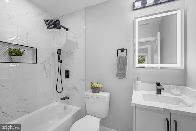 full bathroom with tiled shower / bath, vanity, and toilet