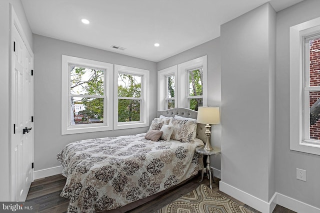 bedroom featuring a closet and dark wood-type flooring