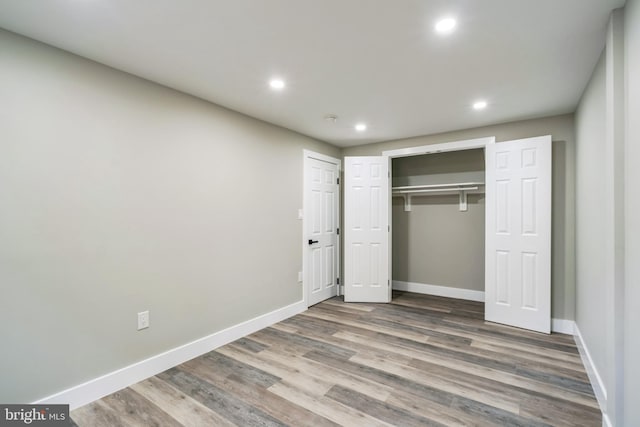 unfurnished bedroom with hardwood / wood-style floors