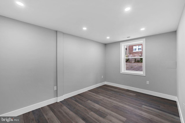 spare room with dark wood-type flooring