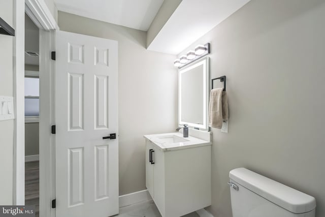 bathroom with vanity, hardwood / wood-style floors, and toilet