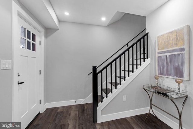 foyer entrance with dark hardwood / wood-style floors