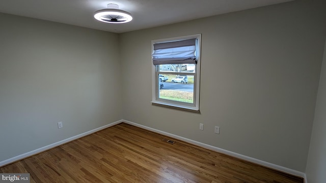 spare room with wood-type flooring