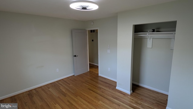 unfurnished bedroom with a closet and light hardwood / wood-style flooring