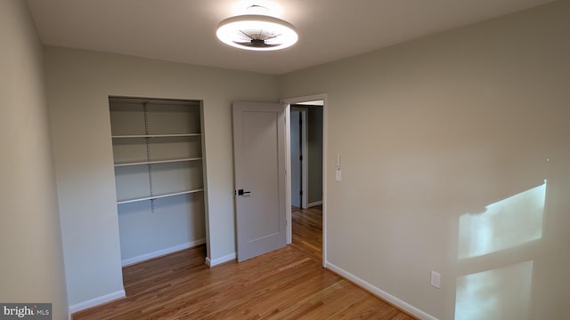 unfurnished bedroom featuring light hardwood / wood-style floors and a closet