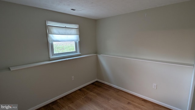 empty room with wood-type flooring