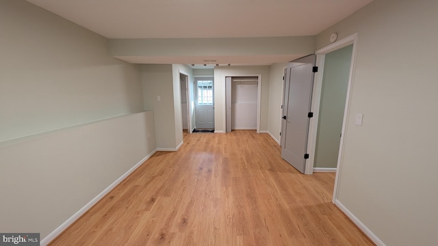 hallway with light wood-type flooring