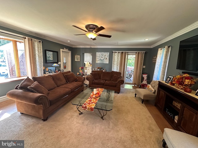 living room with crown molding, light wood-type flooring, and ceiling fan