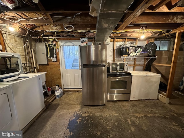 basement featuring electric panel, white refrigerator, separate washer and dryer, and stainless steel refrigerator