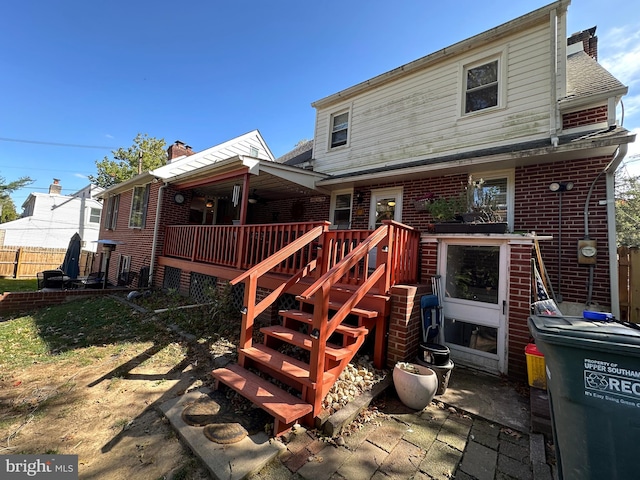 rear view of property with a wooden deck