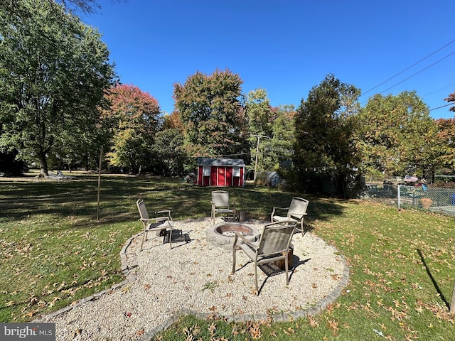 view of yard with a storage shed and an outdoor fire pit