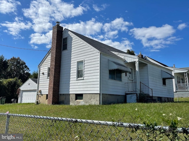 view of home's exterior featuring a lawn and a garage