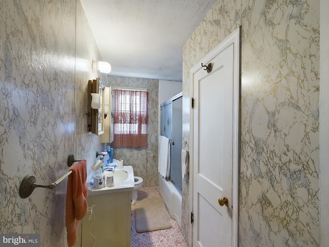 full bathroom with vanity, toilet, and bath / shower combo with glass door