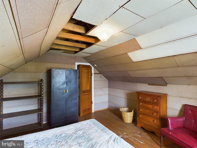 bedroom with dark wood-type flooring and vaulted ceiling