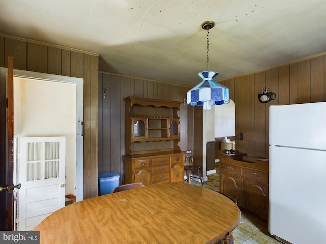 dining space featuring wooden walls