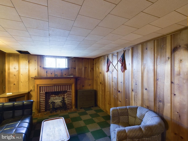 interior space featuring wooden walls and a brick fireplace