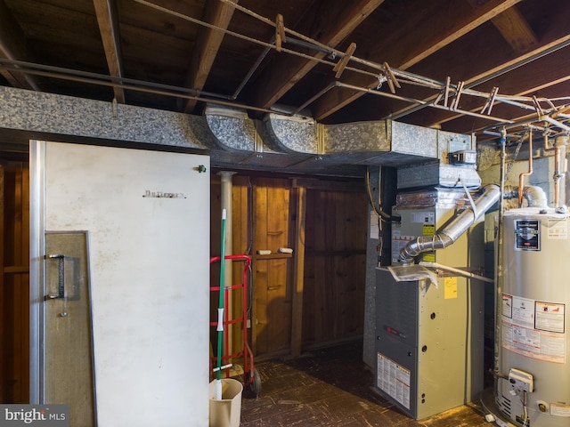 basement featuring wooden walls, heating unit, and water heater