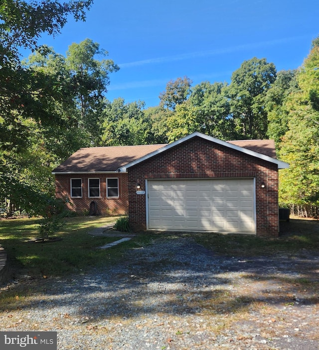 ranch-style home with a garage, brick siding, and driveway