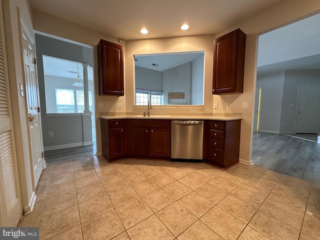 kitchen with dishwasher, light tile patterned floors, a healthy amount of sunlight, and sink