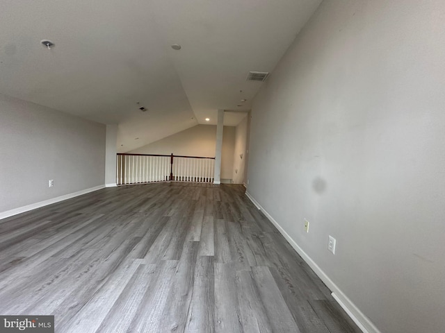 interior space with hardwood / wood-style floors and vaulted ceiling