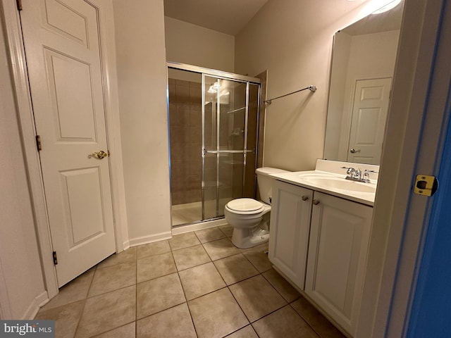 bathroom featuring tile patterned floors, vanity, toilet, and an enclosed shower