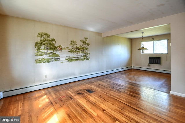 unfurnished room with hardwood / wood-style flooring, a wall mounted air conditioner, and a baseboard heating unit