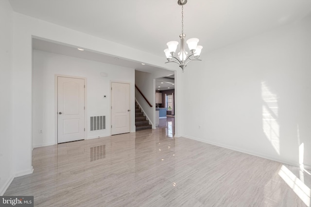 empty room featuring an inviting chandelier