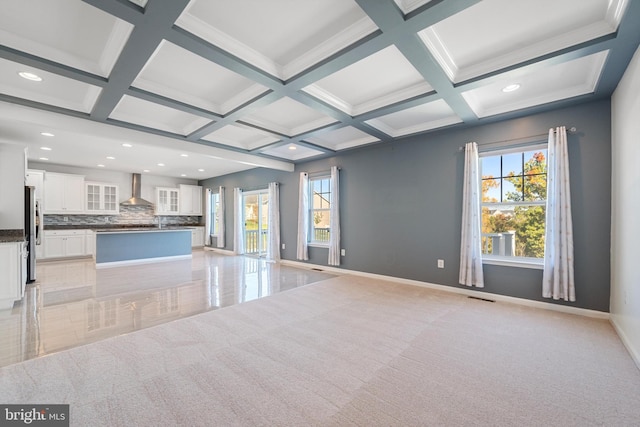 unfurnished living room featuring light carpet, coffered ceiling, beamed ceiling, and ornamental molding